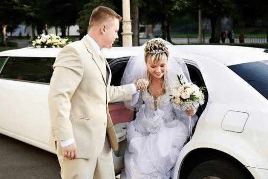 Bride and groom entering a luxury limousine for wedding transportation in Greensboro, NC