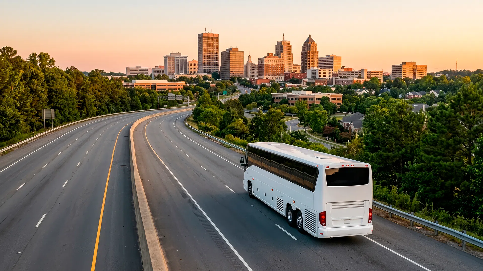 Luxury bus traveling on a highway with a city skyline in the background