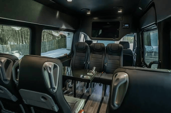 Luxury Sprinter interior with comfortable black passenger seats